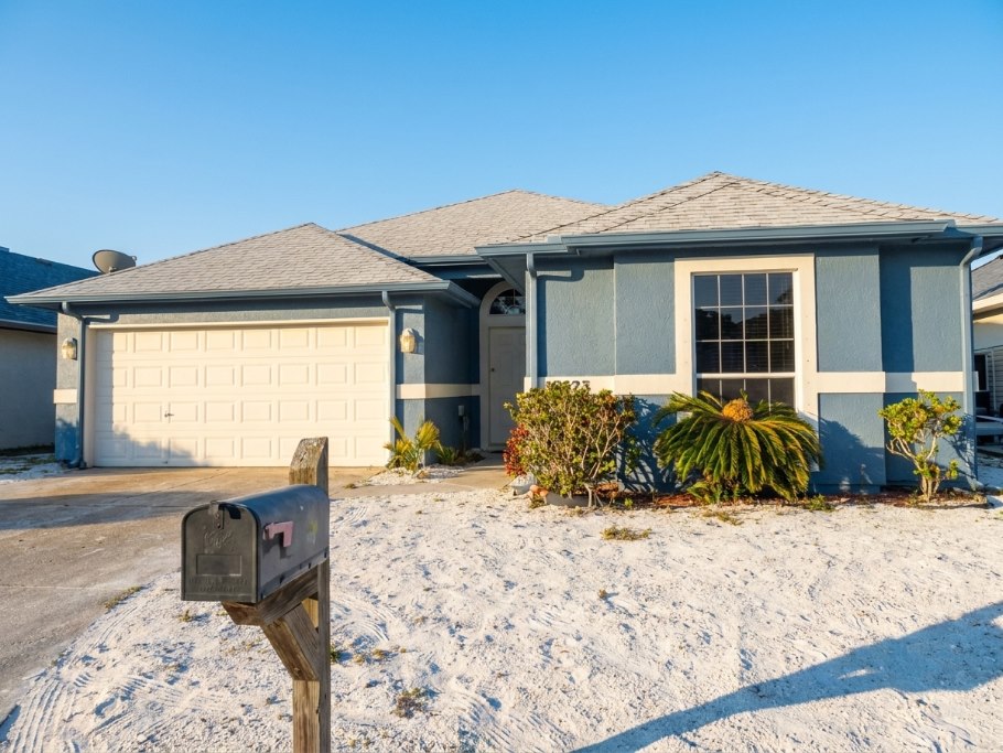 Home exterior after — fresh repaint and cleaned-up yard by One Stop Solutions CC