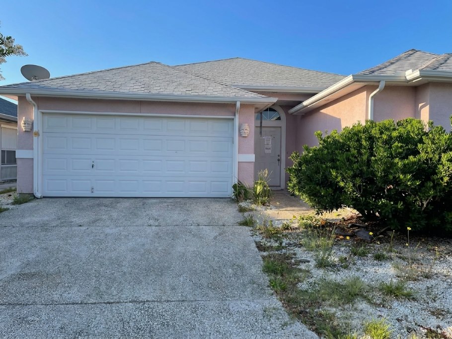 Home exterior before — faded and dated