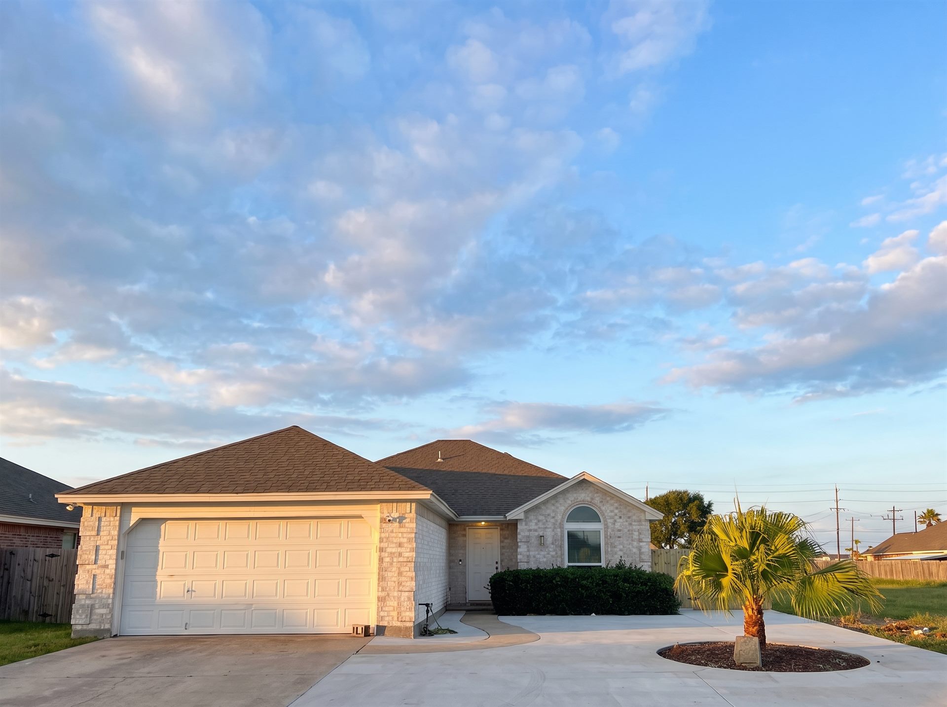 Stone-front home with a new driveway finished by One Stop Solutions CC in Corpus Christi